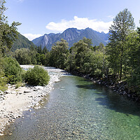 Buy canvas prints of Flowing Skykomish river with cascade mountains  by Thomas Baker