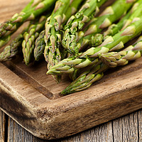 Buy canvas prints of Fresh Asparagus on rustic wooden server board by Thomas Baker
