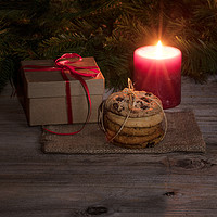 Buy canvas prints of Neatly tied fresh cookies with warm glowing candle by Thomas Baker