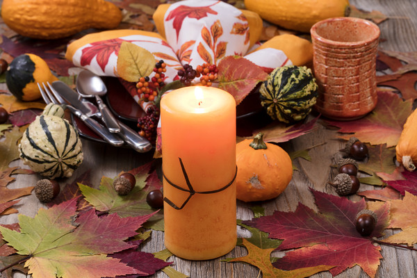 Holiday candle glowing for dinner setting for fall Picture Board by Thomas Baker
