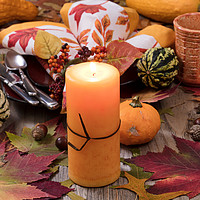 Buy canvas prints of Holiday candle glowing for dinner setting for fall by Thomas Baker