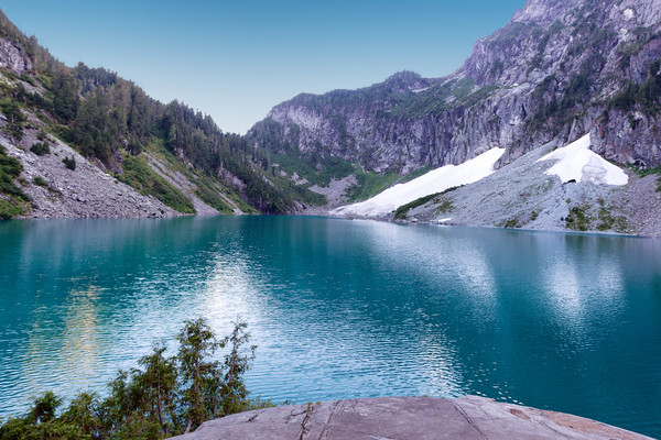 Glacier lake with mountains and snow during summer Picture Board by Thomas Baker