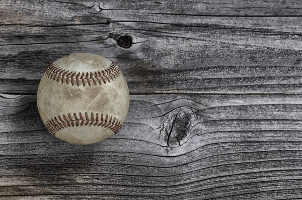 Single used baseball on vintage wooden background. Picture Board by Thomas Baker