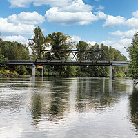 Buy canvas prints of Railroad bridge over large flooded river  by Thomas Baker