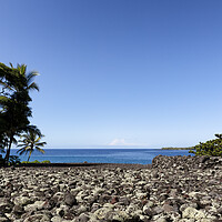 Buy canvas prints of Front view of a rock beach in Hawaii with ocean and sky in backg by Thomas Baker