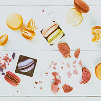 Buy canvas prints of French Macaroons With Tangerine Slices On Table by Radu Bercan