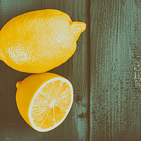 Buy canvas prints of Fresh Yellow Lemons On Wooden Table by Radu Bercan