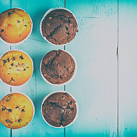 Buy canvas prints of Homemade Chocolate Chip Muffins On Blue Table by Radu Bercan