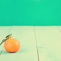 Buy canvas prints of Fresh Tangerine On Blue Table by Radu Bercan