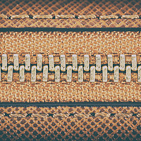 Buy canvas prints of Zipper Closeup On Brown Leather Wallet by Radu Bercan