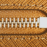 Buy canvas prints of Zipper Closeup On Brown Leather Wallet by Radu Bercan