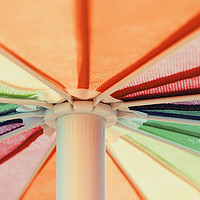 Buy canvas prints of Rainbow Colored Umbrella by Radu Bercan