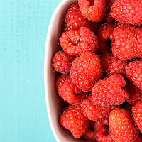 Buy canvas prints of White Bowl Of Red Fresh Raspberries by Radu Bercan
