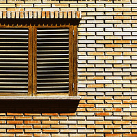 Buy canvas prints of Simple House Window On Red Brick Wall by Radu Bercan