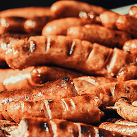 Buy canvas prints of Sausages On Barbecue Grill by Radu Bercan