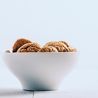 Buy canvas prints of Italian Amaretti Biscuits In White Bowl by Radu Bercan