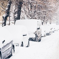 Buy canvas prints of Cars Covered With Fresh White Snow After A Heavy B by Radu Bercan