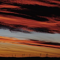 Buy canvas prints of Wind Turbines Farm In The Distance On Beautiful Re by Radu Bercan