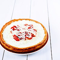 Buy canvas prints of Homemade Strawberry Cheesecake On White Table by Radu Bercan