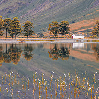Buy canvas prints of Autumn's Embrace at Buttermere Lake by Kevin Elias