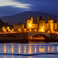 Buy canvas prints of Illuminated Conwy Castle: A Welsh Spectacle by Kevin Elias