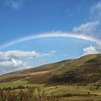 Buy canvas prints of Rainbow over blue sky in the Brecon Beacons by Nick Jenkins