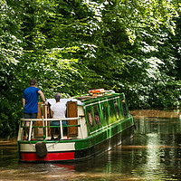 Buy canvas prints of Couple steering a canal boat down the Brecon Canal by Richard Morgan