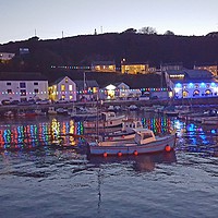 Buy canvas prints of Porthleven Cornwall harbour illuminations at dusk  by Alexandra Stevens