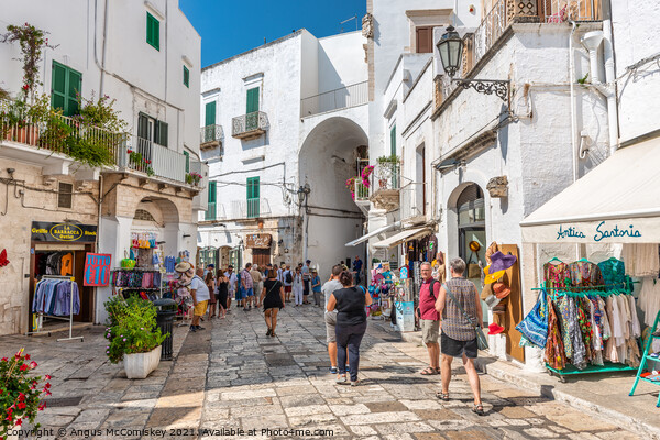 Tourists on Via Cattedrale in Ostuni, Italy Picture Board by Angus McComiskey