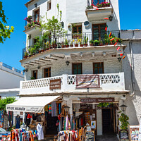 Buy canvas prints of Apartment block and shop in Pampaneira, Spain by Angus McComiskey