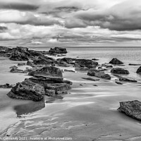 Buy canvas prints of Rocks on Dornoch beach mono by Angus McComiskey