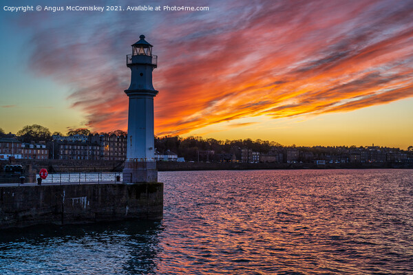 Dramatic sunset at Newhaven Lighthouse, Edinburgh Picture Board by Angus McComiskey