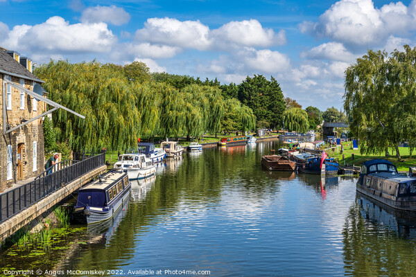 Boats moored on the River Great Ouse at Ely Picture Board by Angus McComiskey