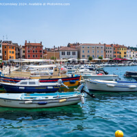 Buy canvas prints of Boats moored in the Port of Rovinj in Croatia by Angus McComiskey