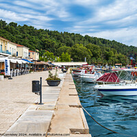 Buy canvas prints of Boats moored on quayside of Katakolon, Greece by Angus McComiskey