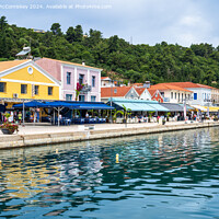 Buy canvas prints of Colourful waterfront buildings at Katakolon Greece by Angus McComiskey
