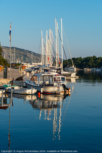 Boats moored in Stari Grad harbour, Croatia Picture Board by Angus McComiskey