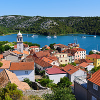 Buy canvas prints of Red tiled rooftops of Skradin by Angus McComiskey