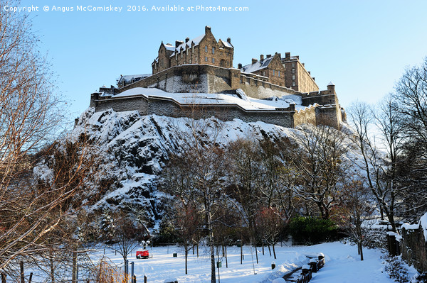 Edinburgh Castle in snow from Princes Street Picture Board by Angus McComiskey