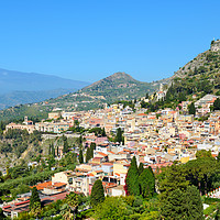 Buy canvas prints of Taormina, Sicily with Mount Etna in background by Angus McComiskey