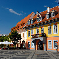 Buy canvas prints of Colourful renovated merchants houses in Sibiu by Angus McComiskey
