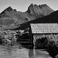 Buy canvas prints of Boat shed with backdrop of Cradle Mountain (mono) by Angus McComiskey