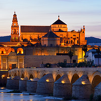 Buy canvas prints of Cordoba Cathedral and Roman Bridge at dusk by Angus McComiskey