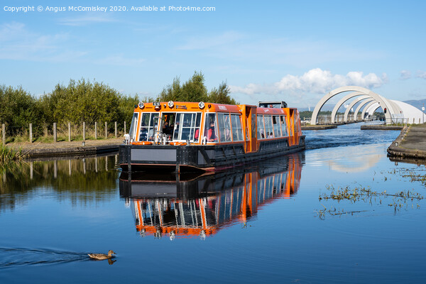 Canal boat leaving Falkirk Wheel behind Picture Board by Angus McComiskey