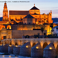 Buy canvas prints of Cordoba Cathedral Mosque and Roman Bridge at dusk by Angus McComiskey