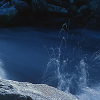 Buy canvas prints of Water spraying in a mountain stream by Colin Woods