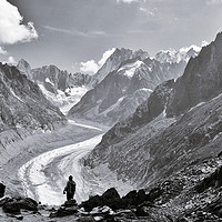 Buy canvas prints of A lone person admiring the Mer de Glace, Chamonix by Colin Woods