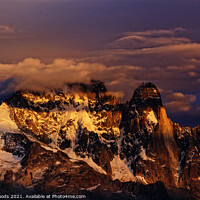Buy canvas prints of Clouds on the summit of the Aiguille Verte at Sunset by Colin Woods