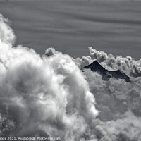Buy canvas prints of An alpine peak emerges from the clouds by Colin Woods