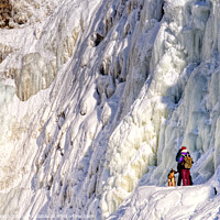 Buy canvas prints of OutdTwo people with their dog at the frozen Chutes de Chaudière at Charny near Quebec City, Canadaoor  by Colin Woods